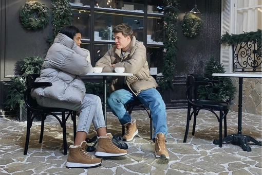 Pärchen im Café draußen am Tisch sitzend mit Merino Schuhen an den Füßen 